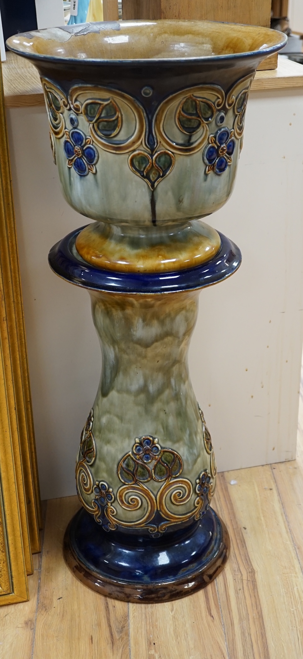 A Royal Doulton jardiniere on stand, 93cm high. Condition - poor